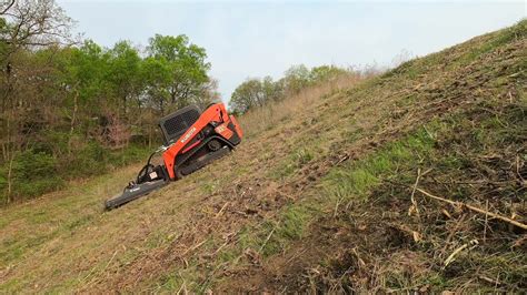 track skid steer on steep slope|slopes mowing with skids.